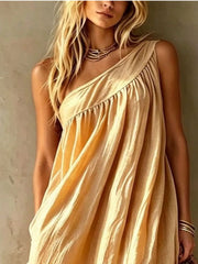 Close view of a pastel yellow one shoulder maxi dress showing the gathered bodice