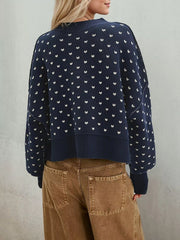 Back view of the navy dotted sweater with dropped shoulders and a ribbed hem
