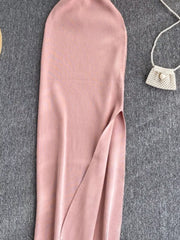Lower skirt of pink ribbed knit midi dress showing side slit detail