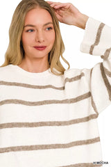 Close up of cream and mocha striped knit sweater with round neckline.