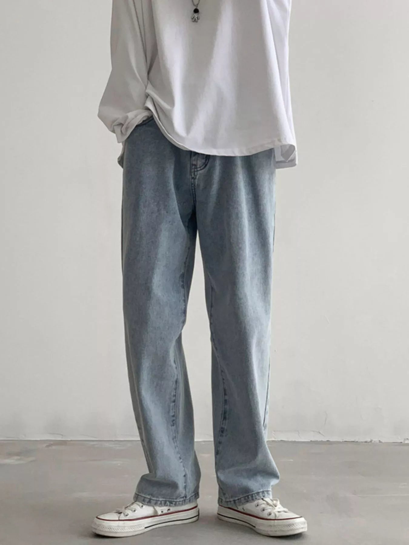 Men's Air Force Blue loose fit wash jeans on model, front view with white sneakers.