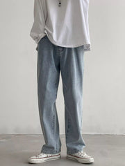Men's Air Force Blue loose fit wash jeans on model, front view with white sneakers.