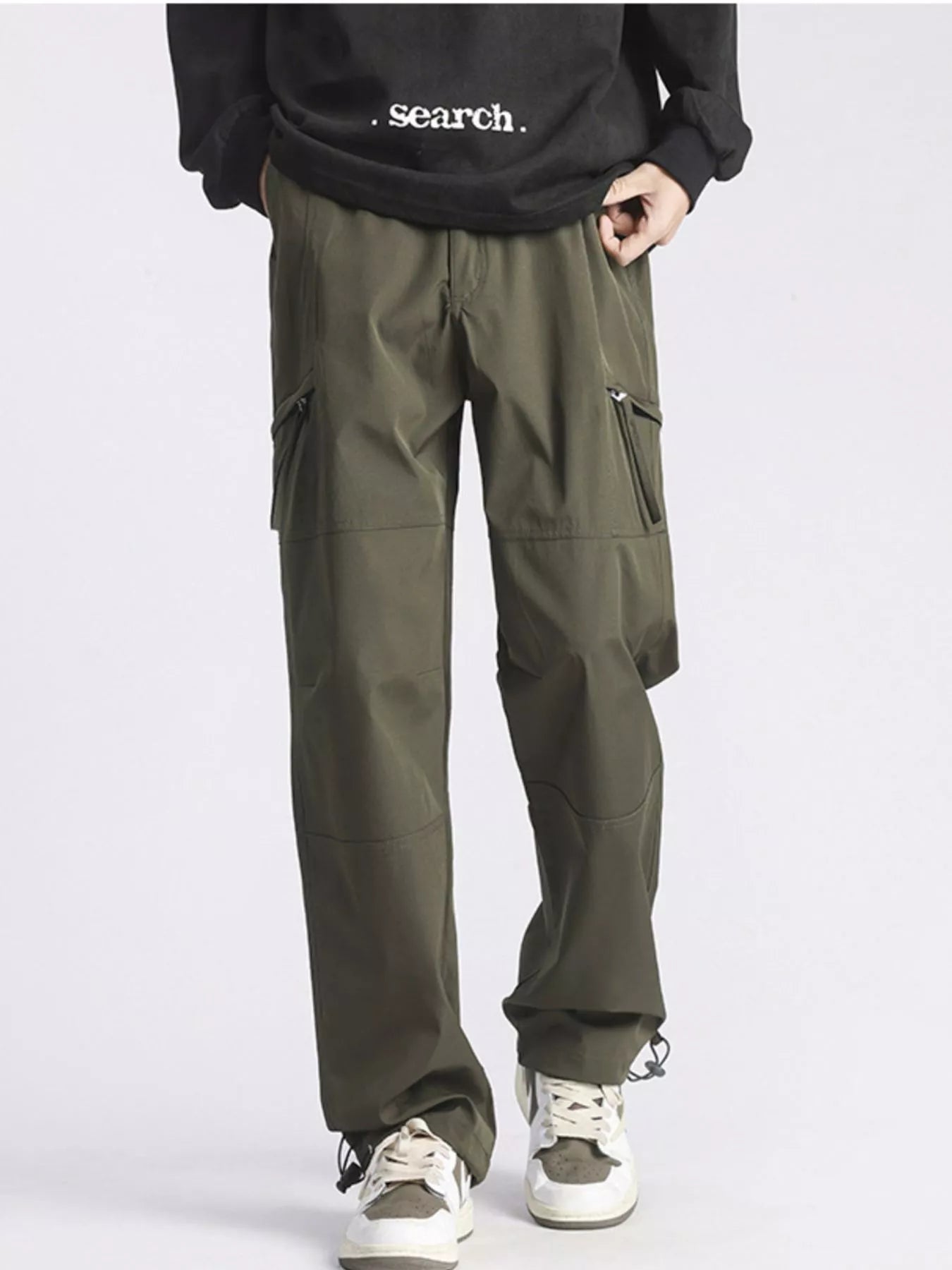 Men's green cargo pants with pockets and a relaxed fit.
