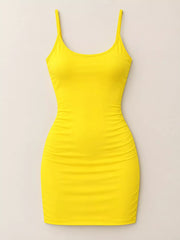 Yellow scoop neck cami dress with thin straps, flat front view on plain background