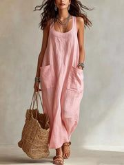 Model wearing pink sleeveless scoop neck maxi dress, full view with large front pockets