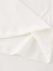 Detail view of the folded hem and stitching on a children's plain white short sleeve tee