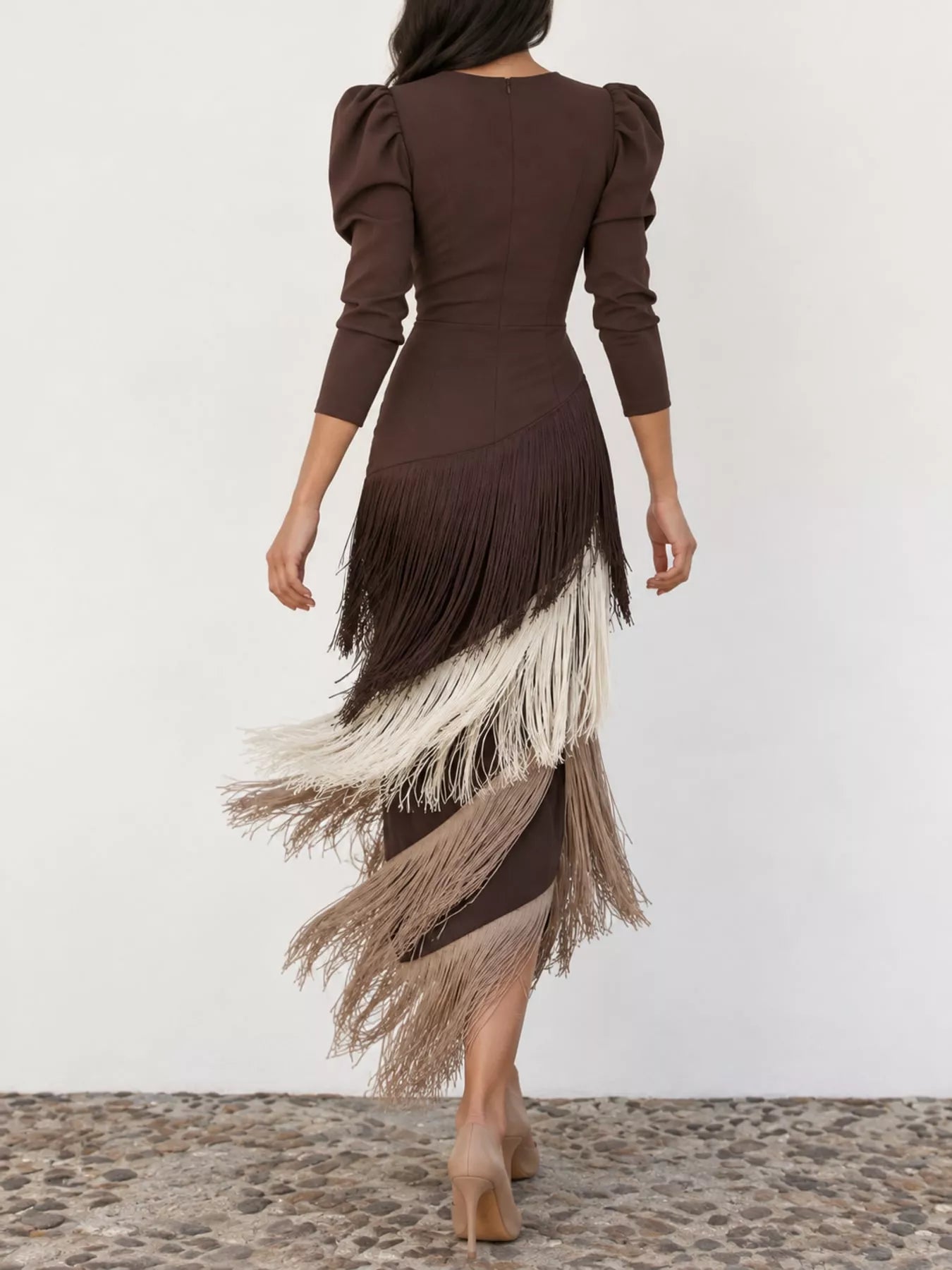 Studio back view of a coffee brown fringed maxi dress with diagonal fringe tiers