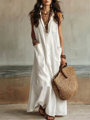 White sleeveless button down linen maxi dress in full front view with woven tote bag