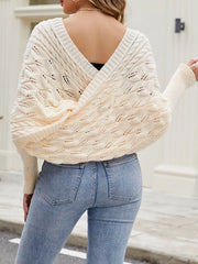 Back view of cream batwing sweater with deep V back and cable knit.