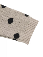 Close up of khaki polka dot sweater sleeve showing ribbed cuff detail