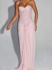 Pink strapless sequin corset maxi dress with draped waist on model, studio front view