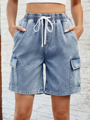 Women's dusty blue denim shorts with a drawstring waist and pockets.