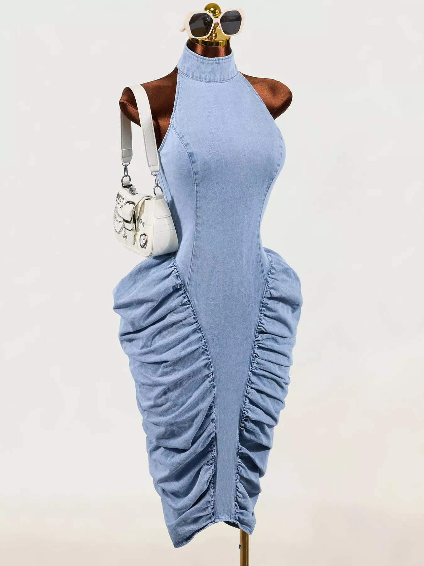 Light blue sleeveless mock neck ruched bodycon denim dress on mannequin, front view