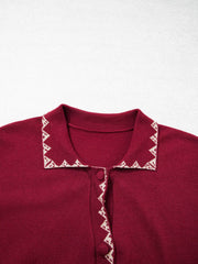 Close view of the burgundy cardigan collar with cream zigzag trim flat lay