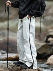 Men's light gray tactical cargo pants with multiple pockets and a drawstring waist.