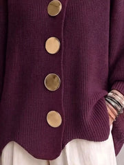 Close up of the burgundy cardigan gold buttons and scalloped hem