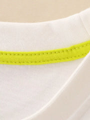 Close-up of cream children's t-shirt neckline with bright lime green inner trim