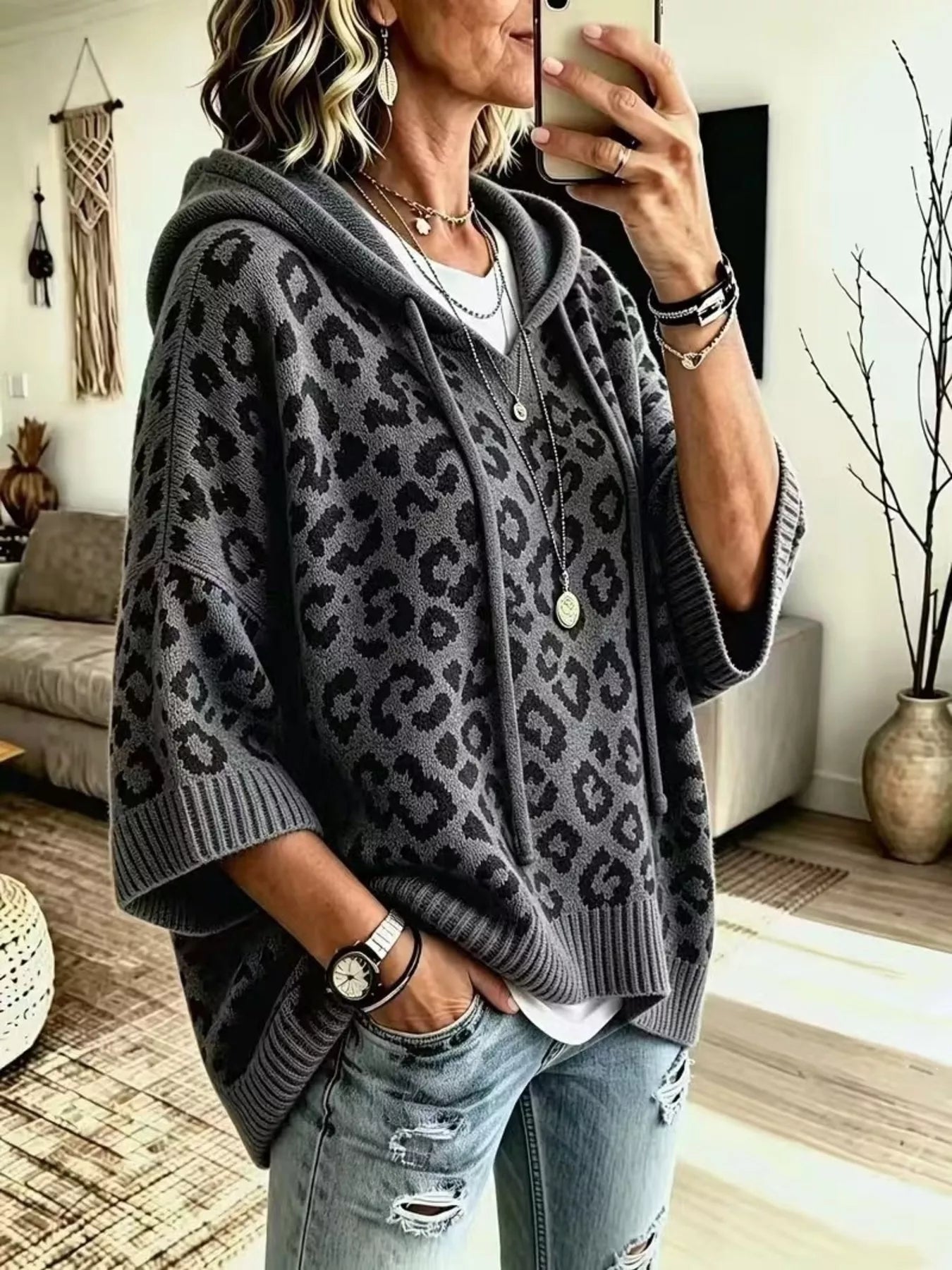 Front angle view of gray leopard print oversized hooded knit sweater with wide sleeves