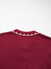 Close back view of the burgundy cardigan collar with cream zigzag trim