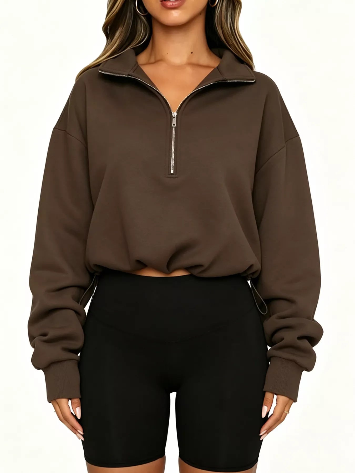 Straight front view of brown half zip sweatshirt with drawstring hem and ribbed cuffs