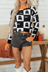 Front view of a checkerboard ghost sweater with orange trim and cropped length