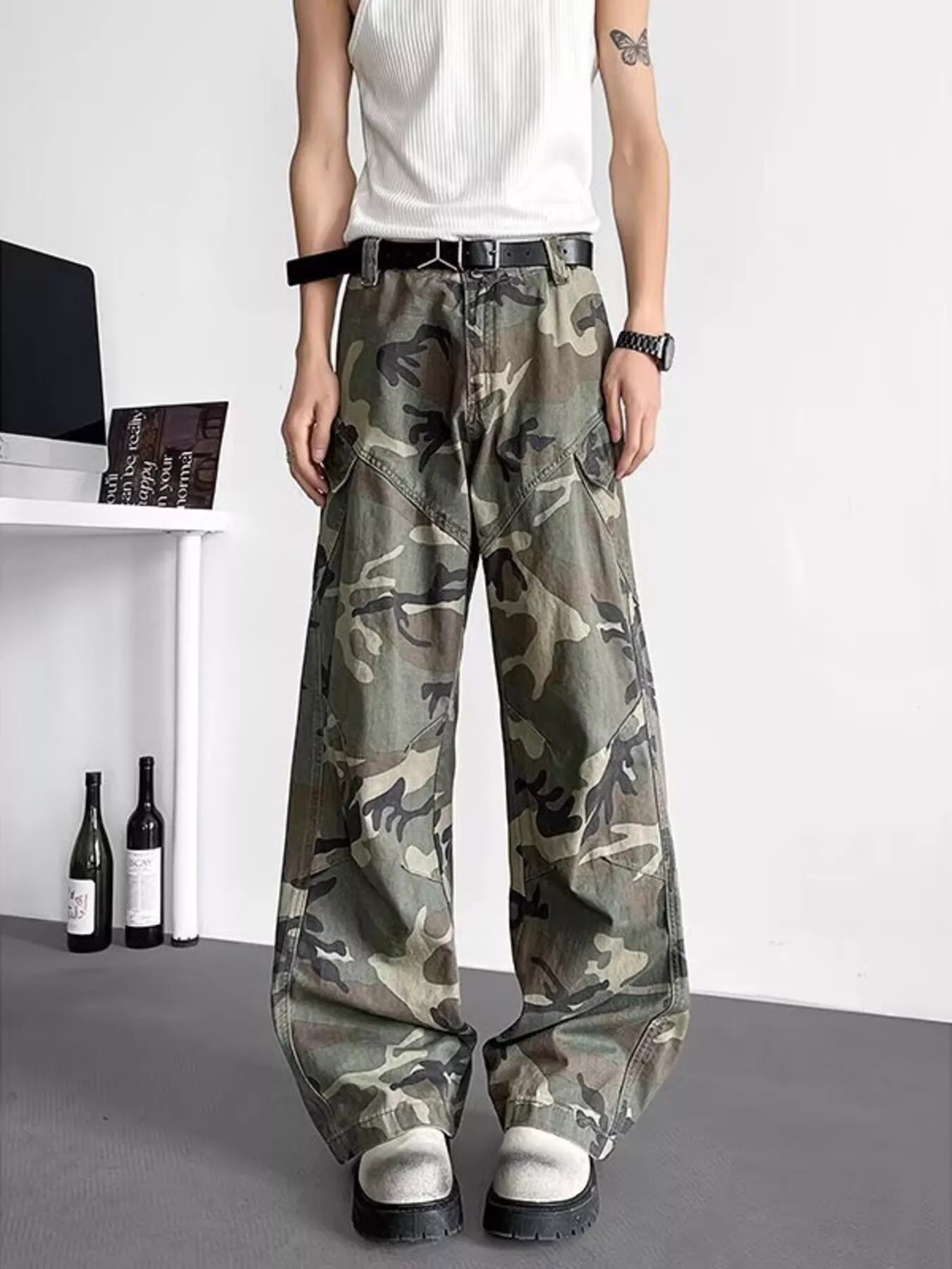 Men's green camouflage loose-fit cargo pants with a drawstring waist and pockets.