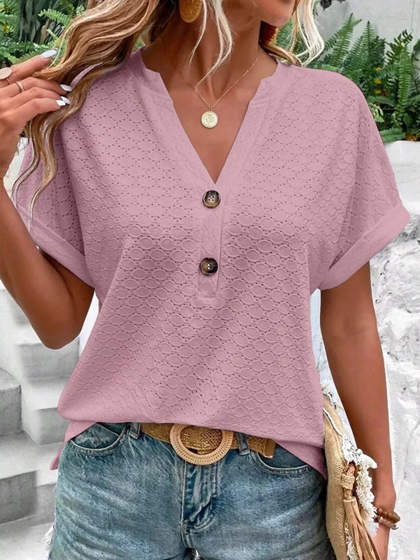 Mauve notched short-sleeve top with eyelet texture, button front, and relaxed fit, shown on a model