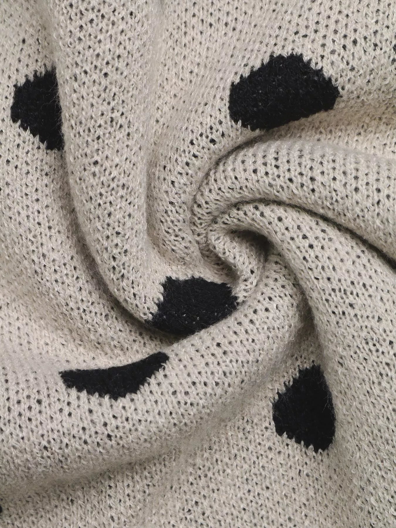 Close up of khaki polka dot knit fabric showing texture and dot pattern