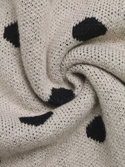 Close up of khaki polka dot knit fabric showing texture and dot pattern