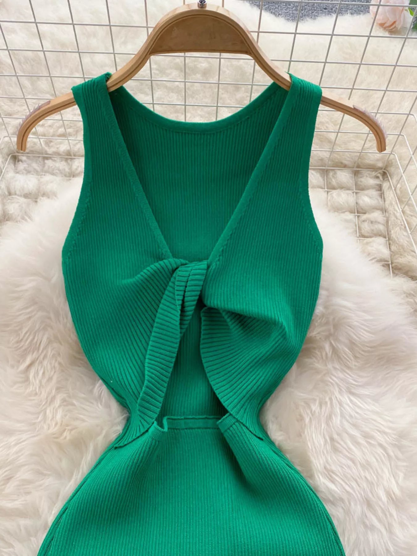 Close back view of emerald green ribbed knit dress showing knotted open back detail