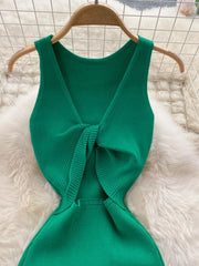 Close back view of emerald green ribbed knit dress showing knotted open back detail