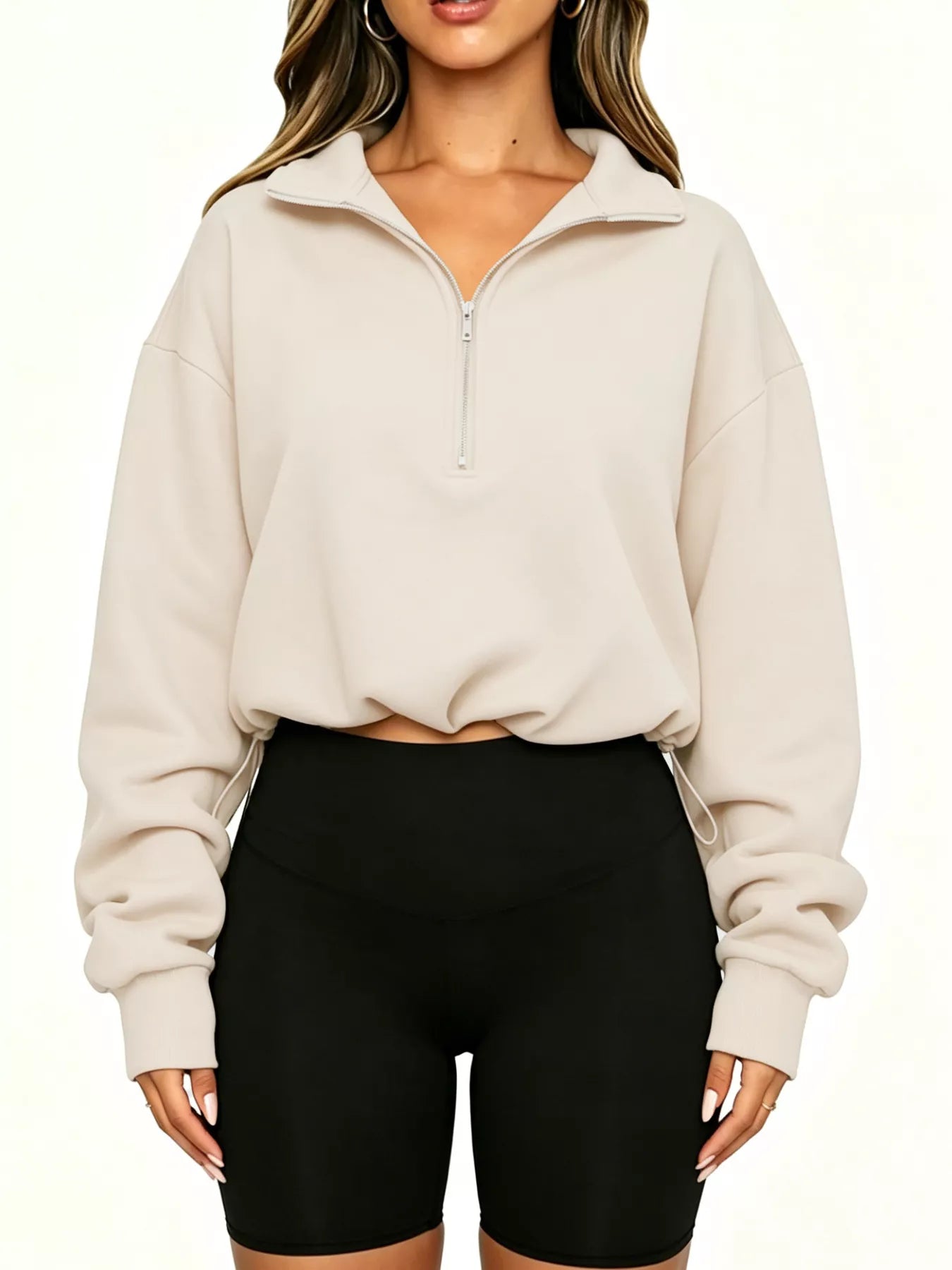 Straight front view of apricot half zip sweatshirt with drawstring hem and ribbed cuffs