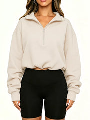 Straight front view of apricot half zip sweatshirt with drawstring hem and ribbed cuffs
