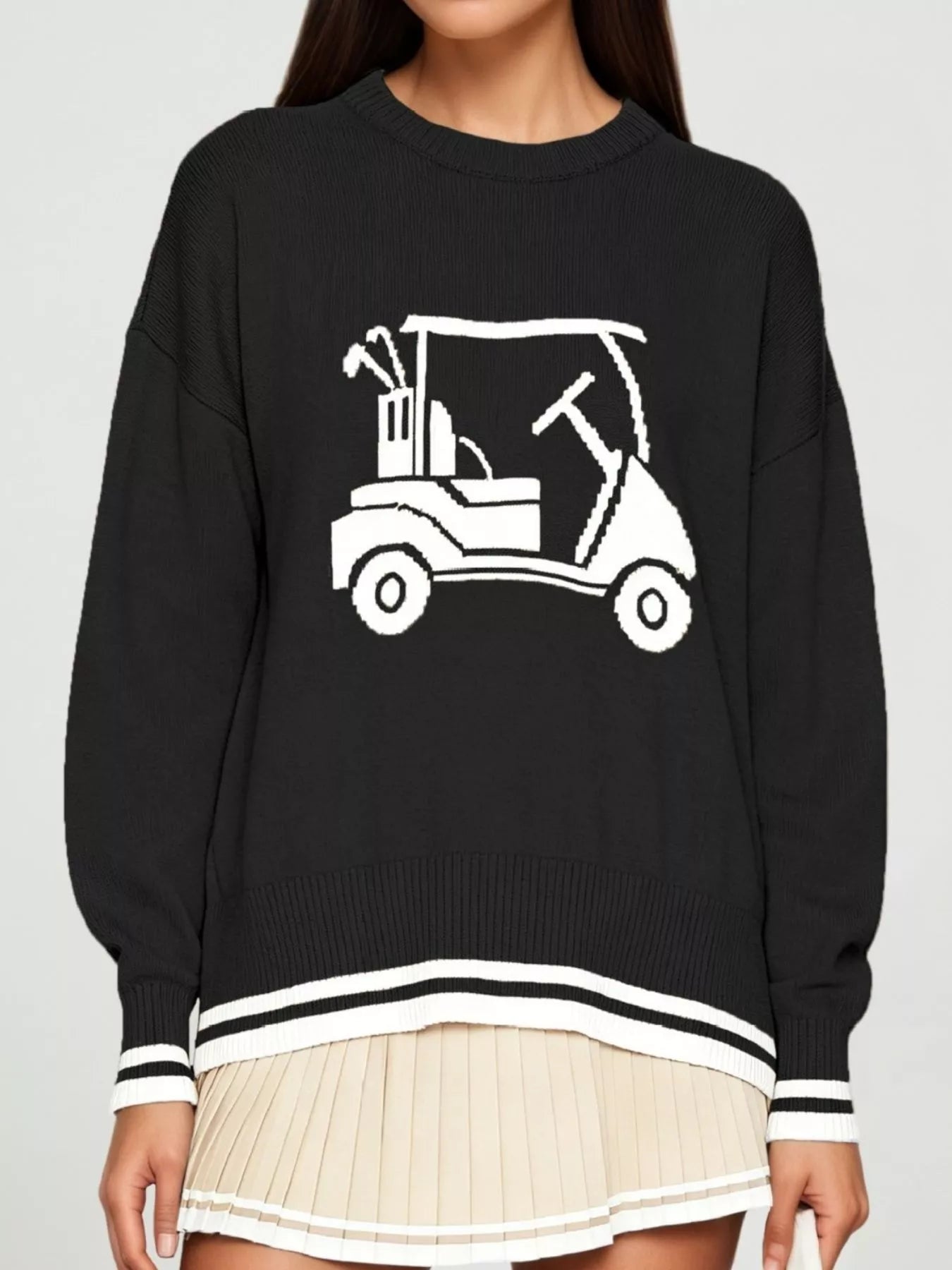 Front view of a black dropped shoulder sweater with a white golf cart graphic and striped trim.