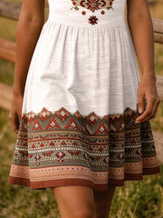 Close view of white tribal print dress skirt with patterned border hem
