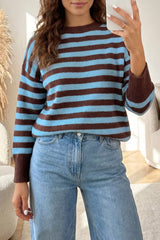 Mirror selfie front view of the blue and brown striped sweater with brown cuffs and light jeans