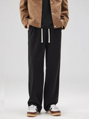 Men's black pants with a relaxed fit and drawstring waist.