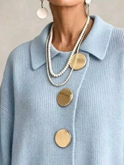 Close up of the sky blue cardigan collar and large gold buttons