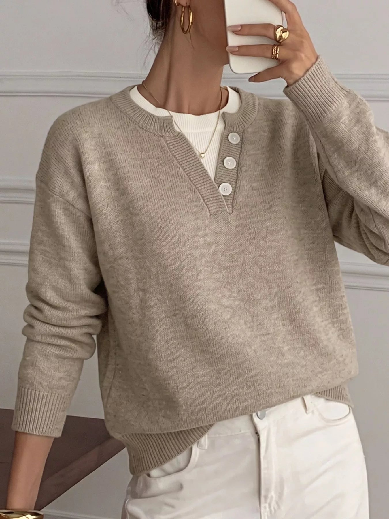 Mirror view of khaki dropped shoulder sweater with V neck and white buttons