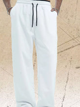 Men's white wide-leg pants with a drawstring waist.