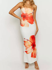 Full length front studio view of an orange floral print strapless bodycon maxi dress