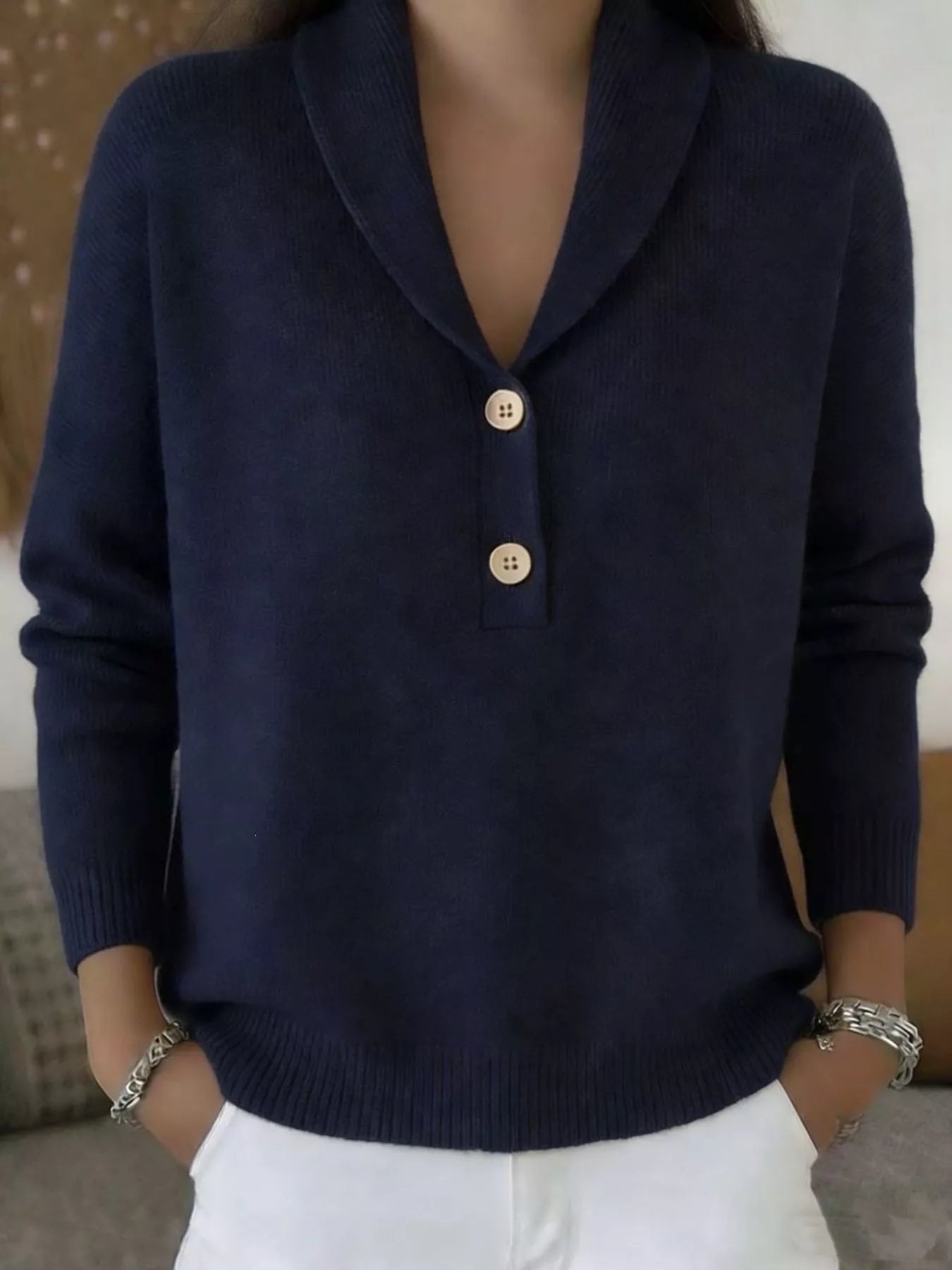 On-model front view of a navy shawl collar sweater with cream buttons