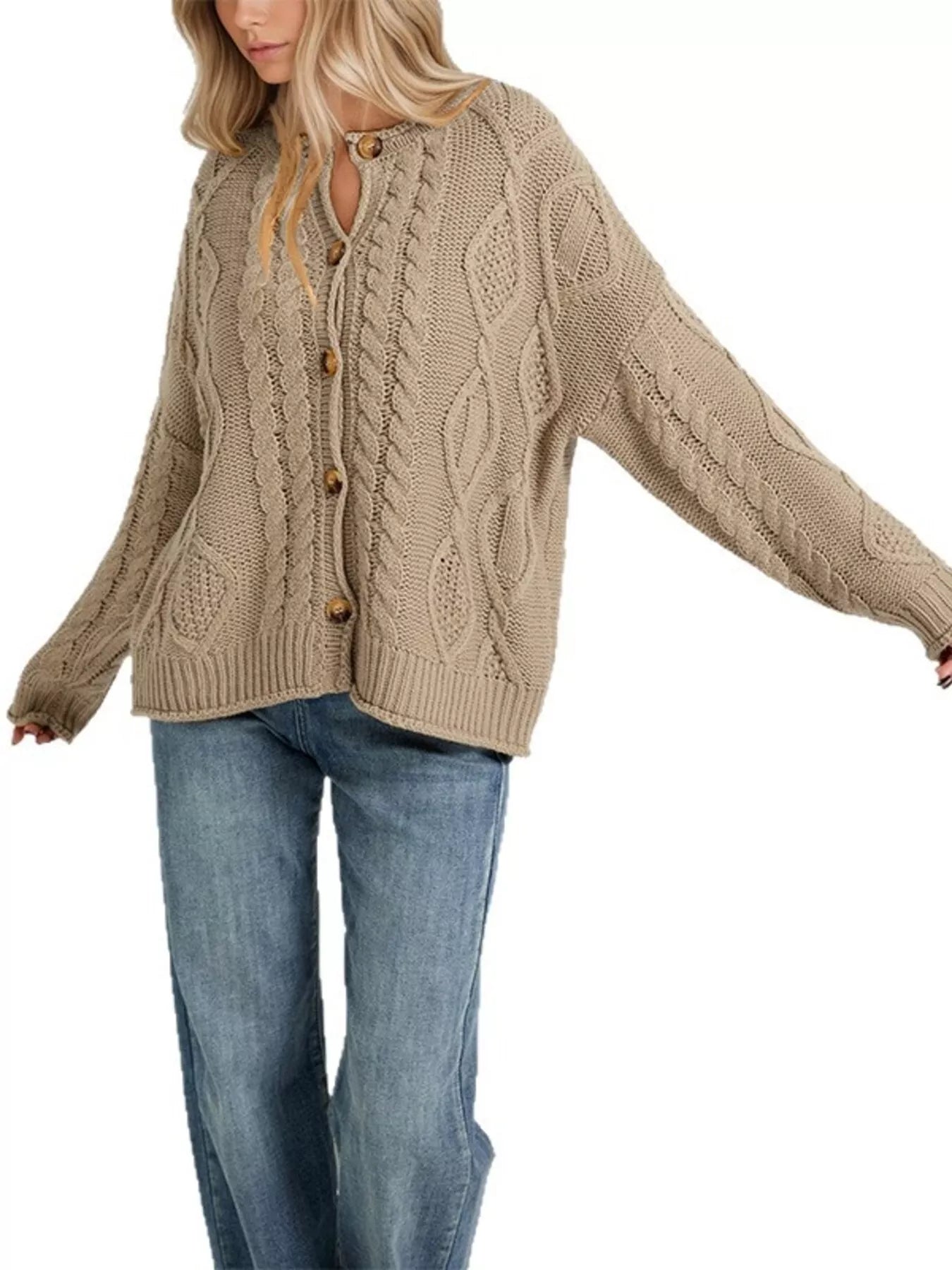 Front view of khaki cable knit button down cardigan fully buttoned with blue jeans