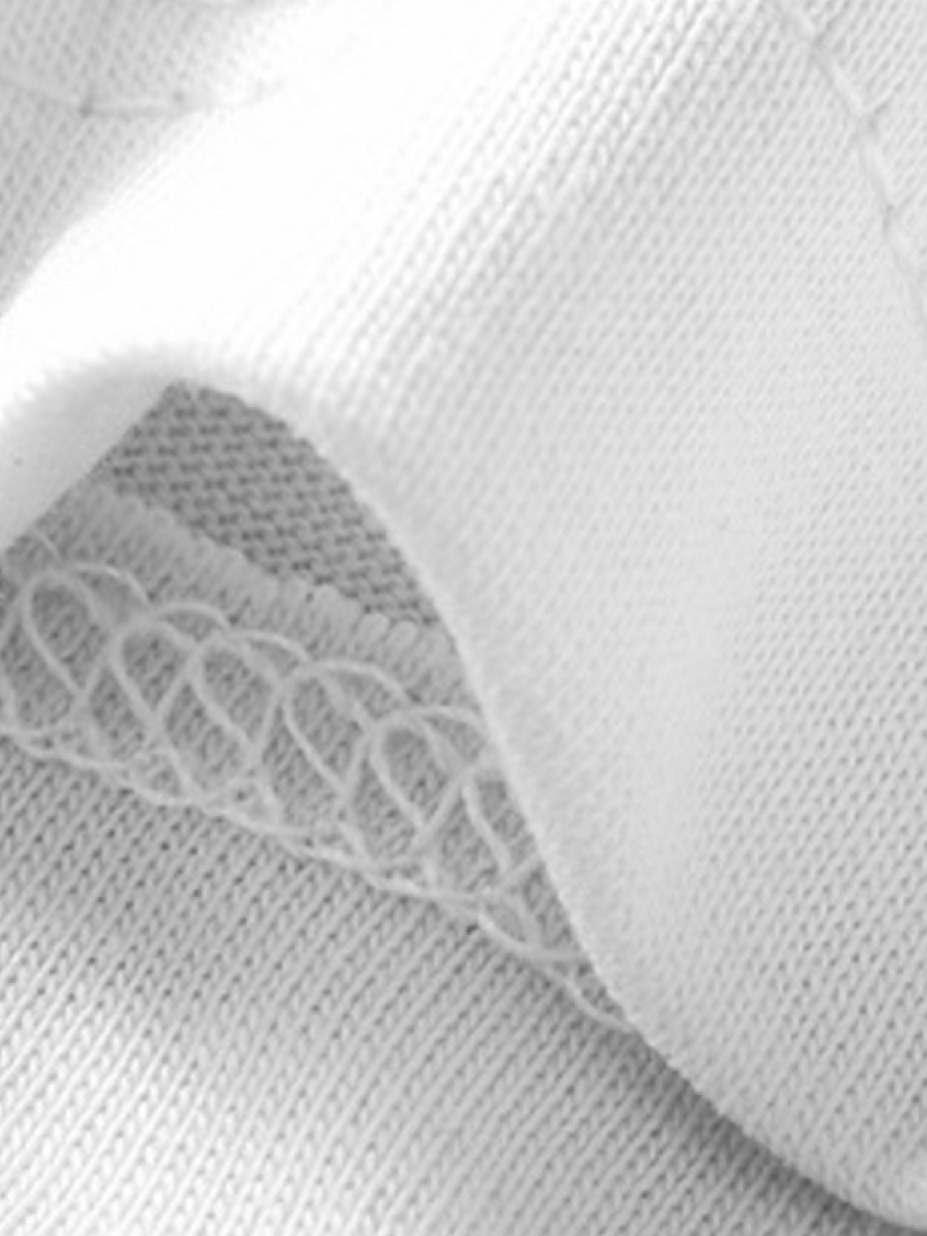 Close-up of the white fabric and neat stitching along the hem of a children's T-shirt