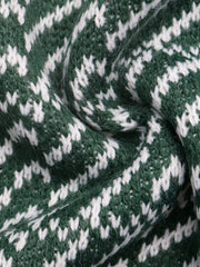 Close-up of the green and white geometric knit fabric texture