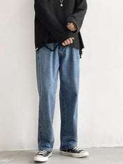 Men's Light Blue loose fit wash jeans on model, front view with black top.