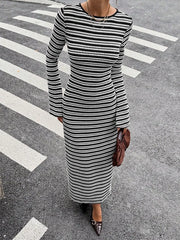 On-model front view of the black and white striped sweater dress from a high angle