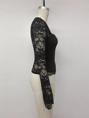 Side view of black square-neck top with sheer floral lace long sleeves and scalloped hem.