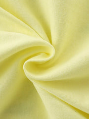 Close view of the light yellow children's tee fabric gathered in a soft swirl showing knit texture
