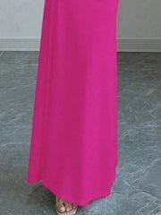 Close view of vivid pink off shoulder maxi skirt hem and floor length fabric